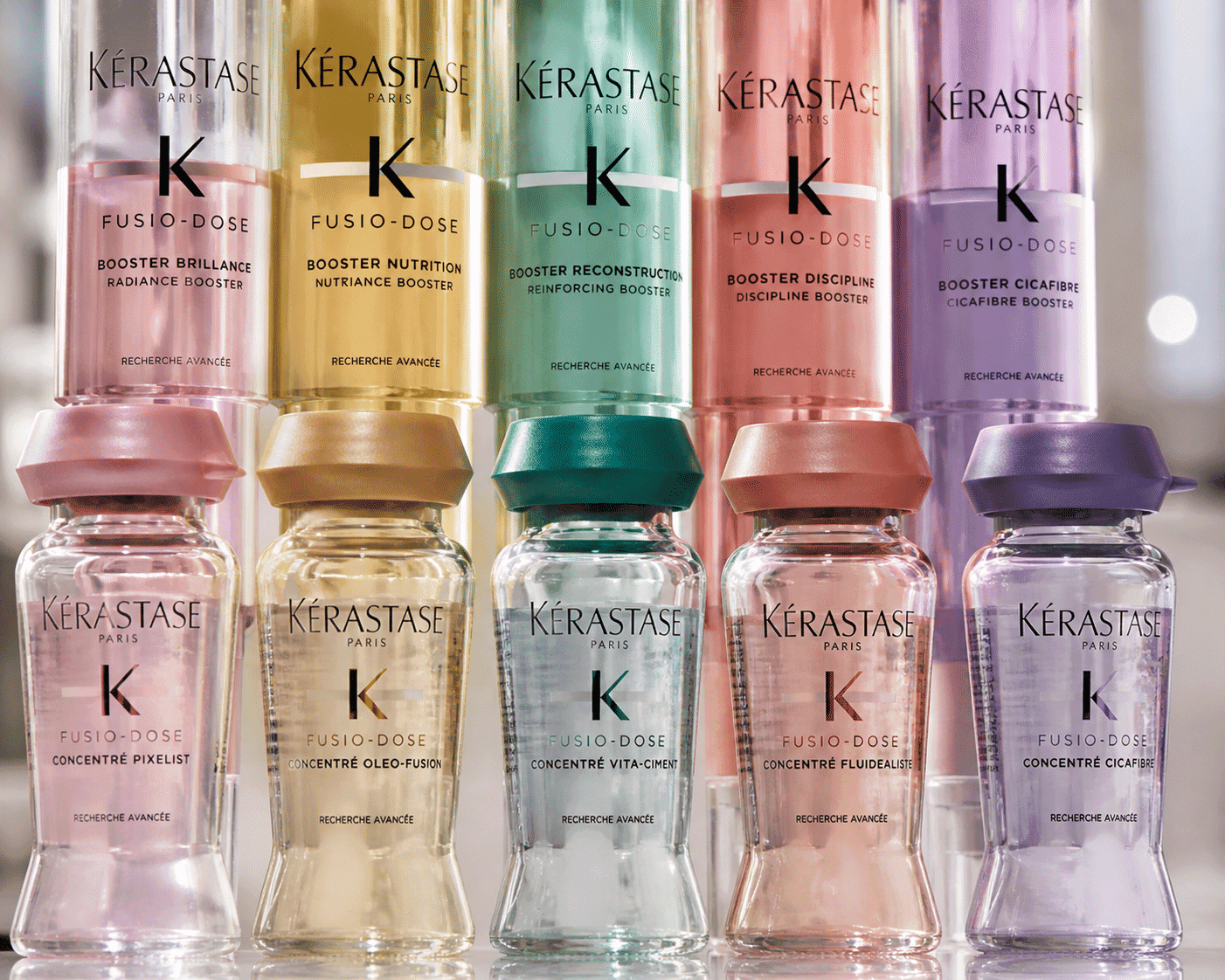 Kérastase Fusio-Dose bottles arranged in two rows, showcasing different formulas and colors.