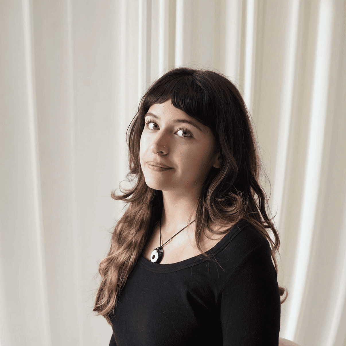 Portrait of Frankie Bass-Duque, a professional stylist at Salt and Waves Salon, showcasing their expertise and style.
