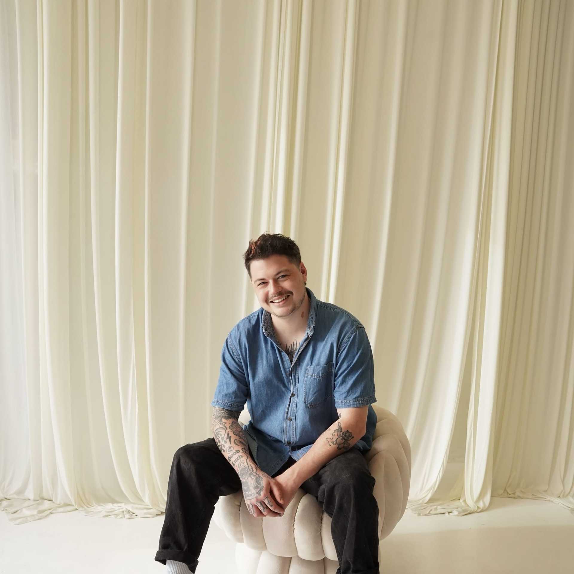 Portrait of Kyle Balstad, a professional stylist at Salt and Waves Salon, showcasing their expertise and style.