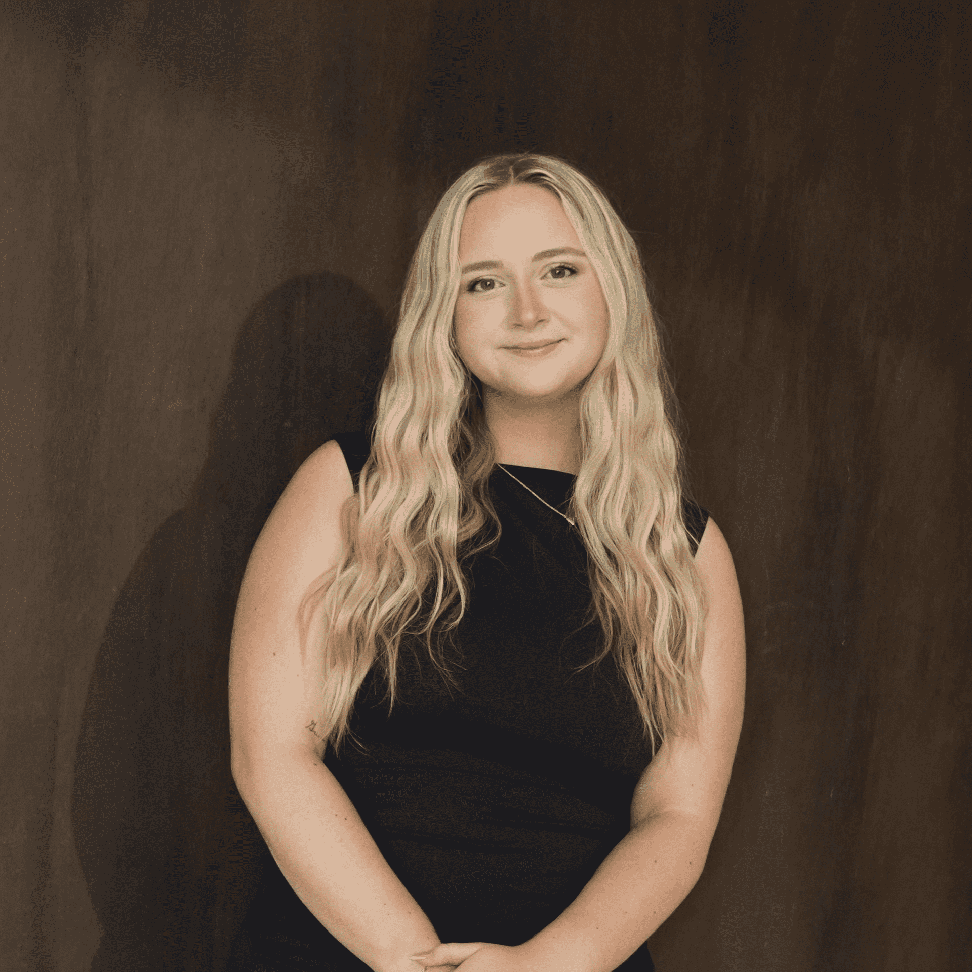 Portrait of Madilyn Griner, a professional stylist at Salt and Waves Salon, showcasing their expertise and style.